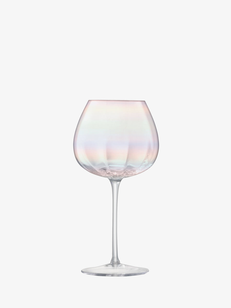 A single lsa-international Red Wine Glass with a wide bowl and long stem is displayed on a plain white background, highlighting exquisite mouth-blown craftsmanship and a shimmering iridescent lustre.