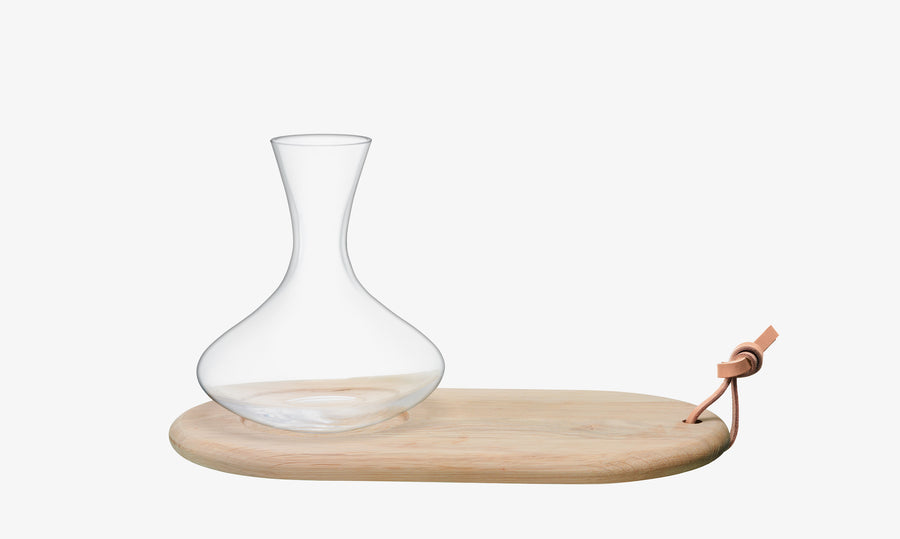 The lsa-international Carafe & Oak Cheese Board includes a clear glass carafe with a wide base, ideal for wine aeration, elegantly placed on a light oak serving board finished with a leather loop threaded through one end.