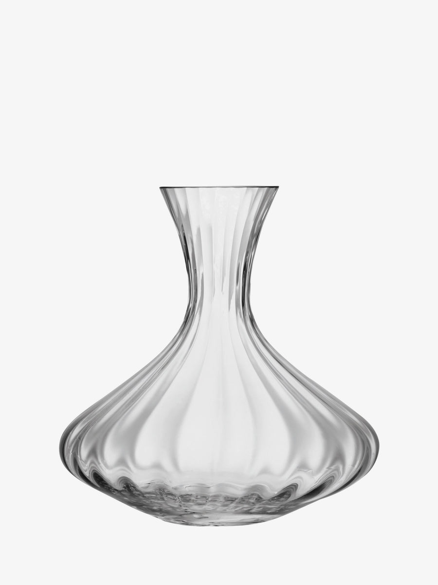 The lsa-international Carafe is a mouth-blown clear glass decanter with a wide base and narrow neck, featuring elegant wavy contours and a transparent appearance, shown against a plain white background.