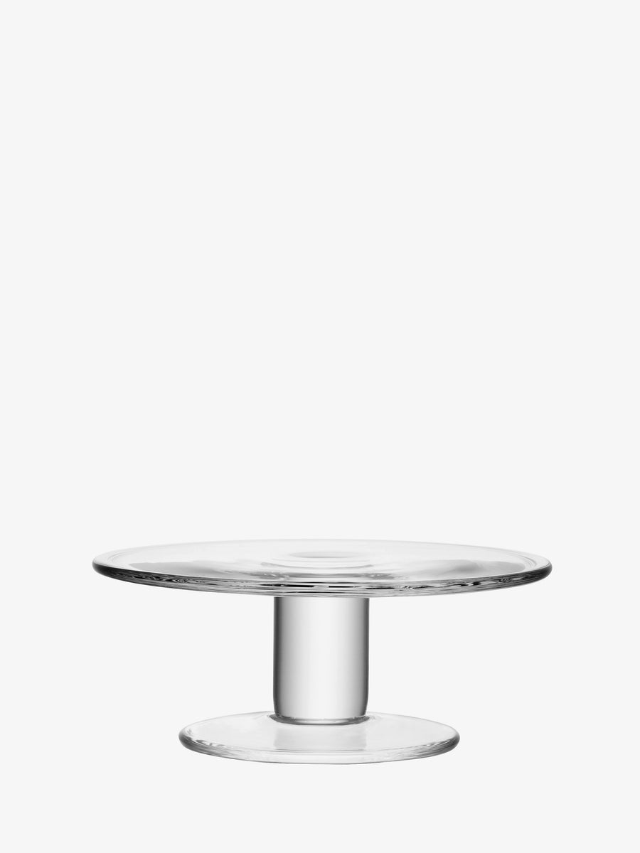 The lsa-international Cakestand is crafted from clear, mouth-blown glass and features a wide, flat top and a sturdy cylindrical base with a thick rim, shown against a plain white background.