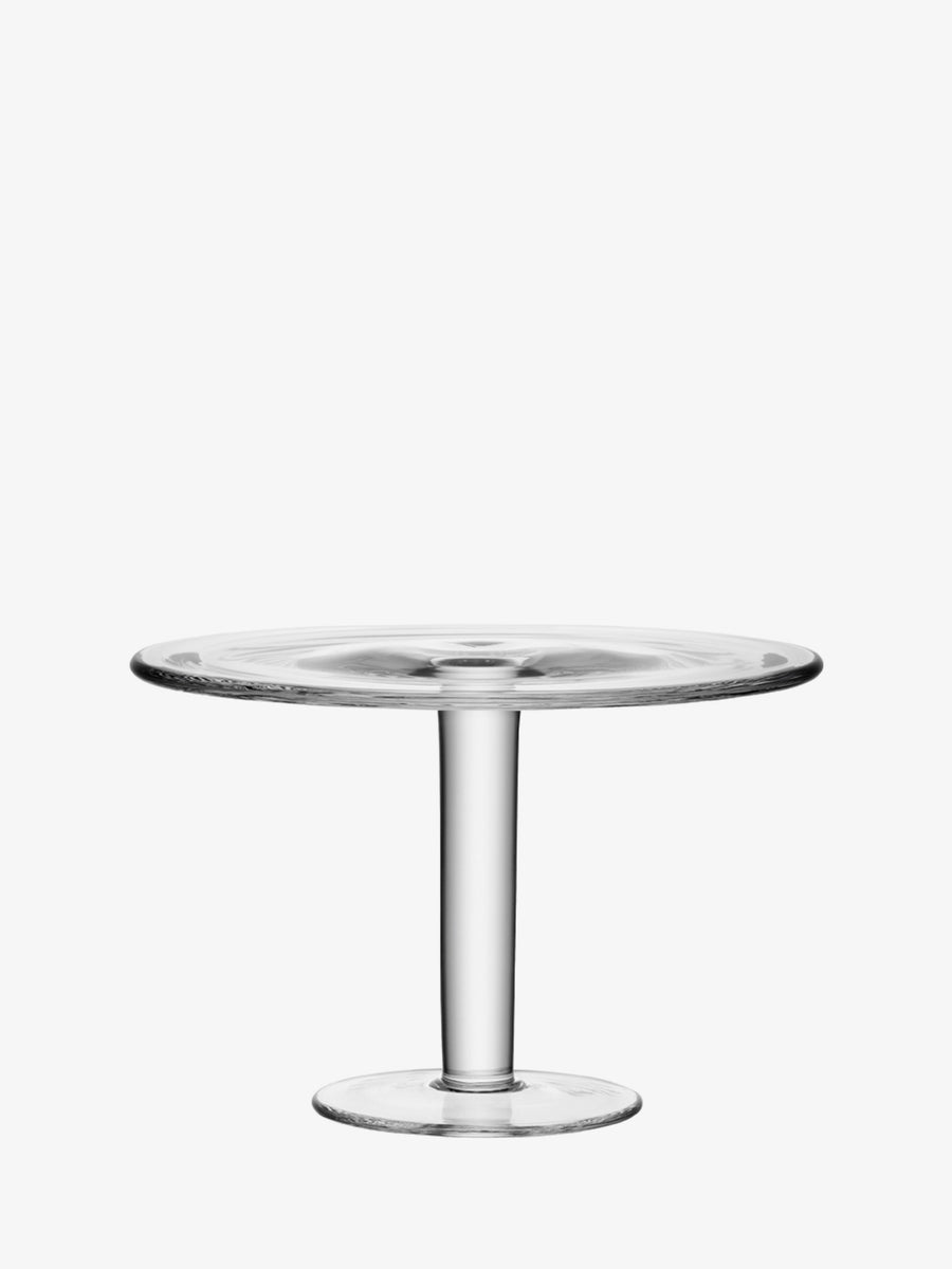 The lsa-international Cakestand features clear, mouth-blown glass with a wide, flat top and a sturdy single pedestal base. Displayed against a plain white background, this tall-stemmed cakestand highlights the brand’s elegant craftsmanship and timeless design.