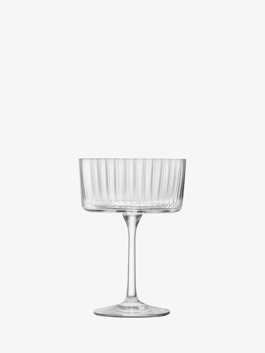 The lsa-international Champagne/Cocktail Glass features a clear glass design with a wide, shallow bowl, slender stem, flat base, and a textured vertical stripe pattern—an elegant choice for modern glassware or stylish champagne saucers—presented against a plain white background.