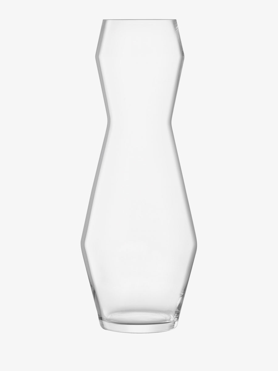 A modern, mouth-blown Vase by lsa-international with a clear geometric, angular silhouette is displayed empty against a plain white background.