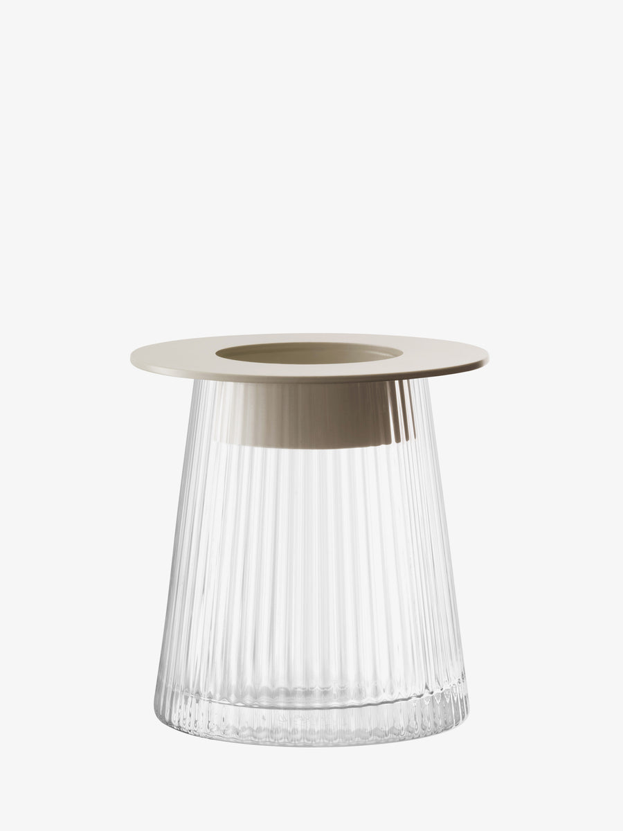 The lsa-international Lantern/Vase is a modern, clear mouth-blown glass piece featuring vertical ridges and a wide, flat, beige-colored rim at the top. Shown against a plain white background, this elegant vase showcases artisanal craftsmanship and contemporary style.