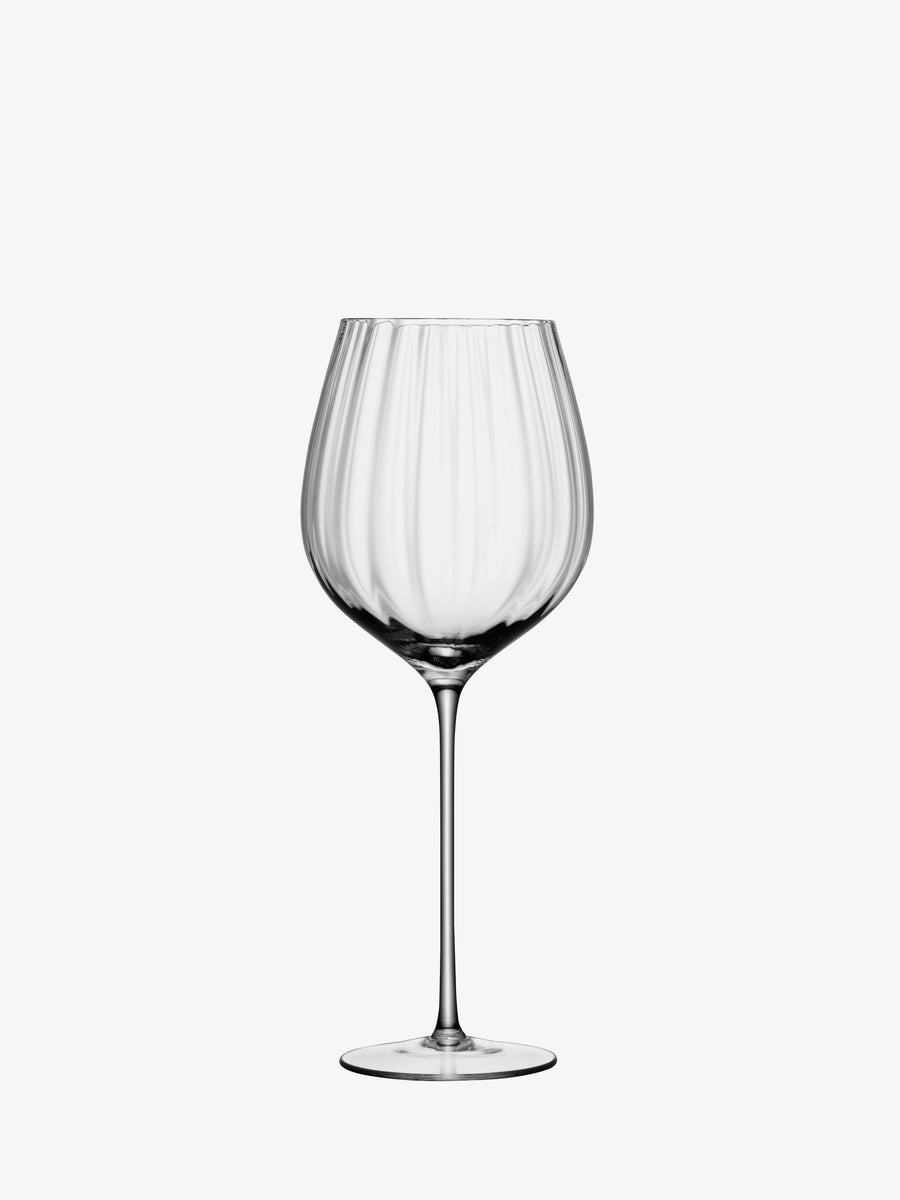 A clear, empty lsa-international Red Wine Glass featuring a wide bowl and long stem, presented against a plain white background.