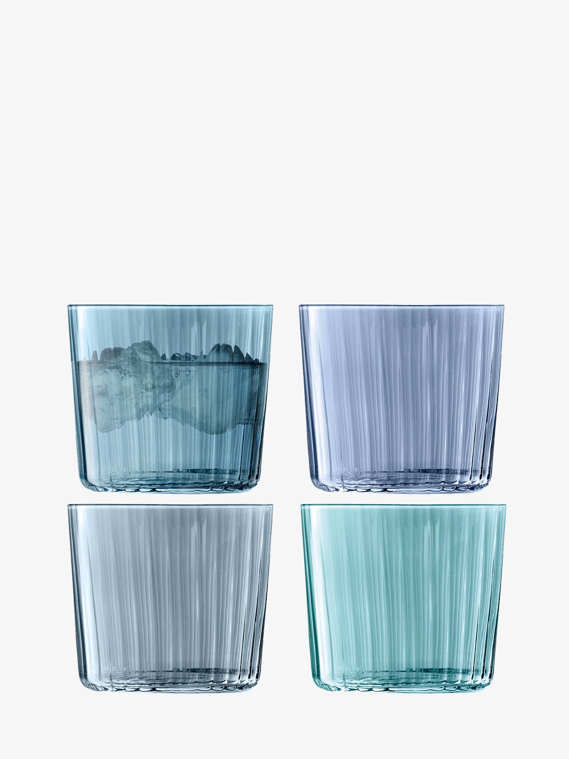 Four lsa-international Tumbler glasses in varying shades of blue and green are arranged in a square, set against a plain white background. The top left Tumbler holds ice, while the other stackable glasses are empty.