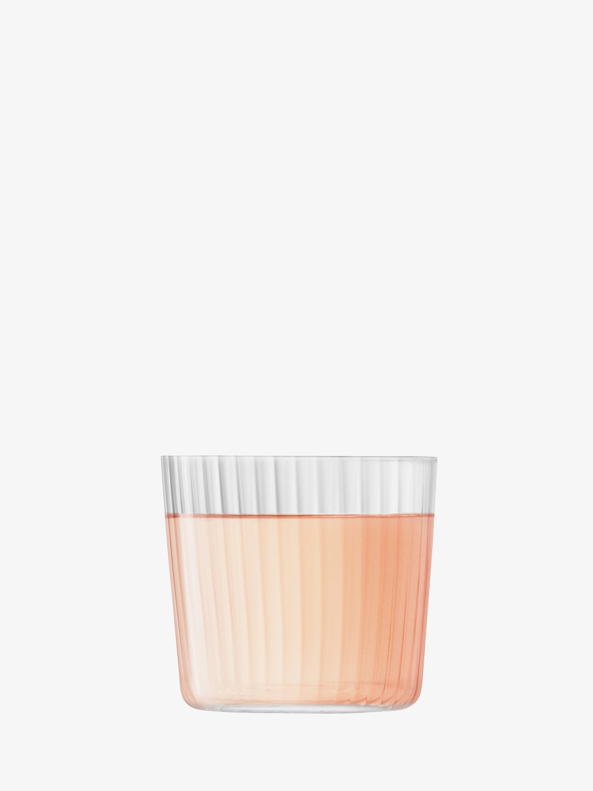 A lsa-international Tumbler with fine, clear ribbed walls is filled halfway with a light pink liquid and set against a plain white background.