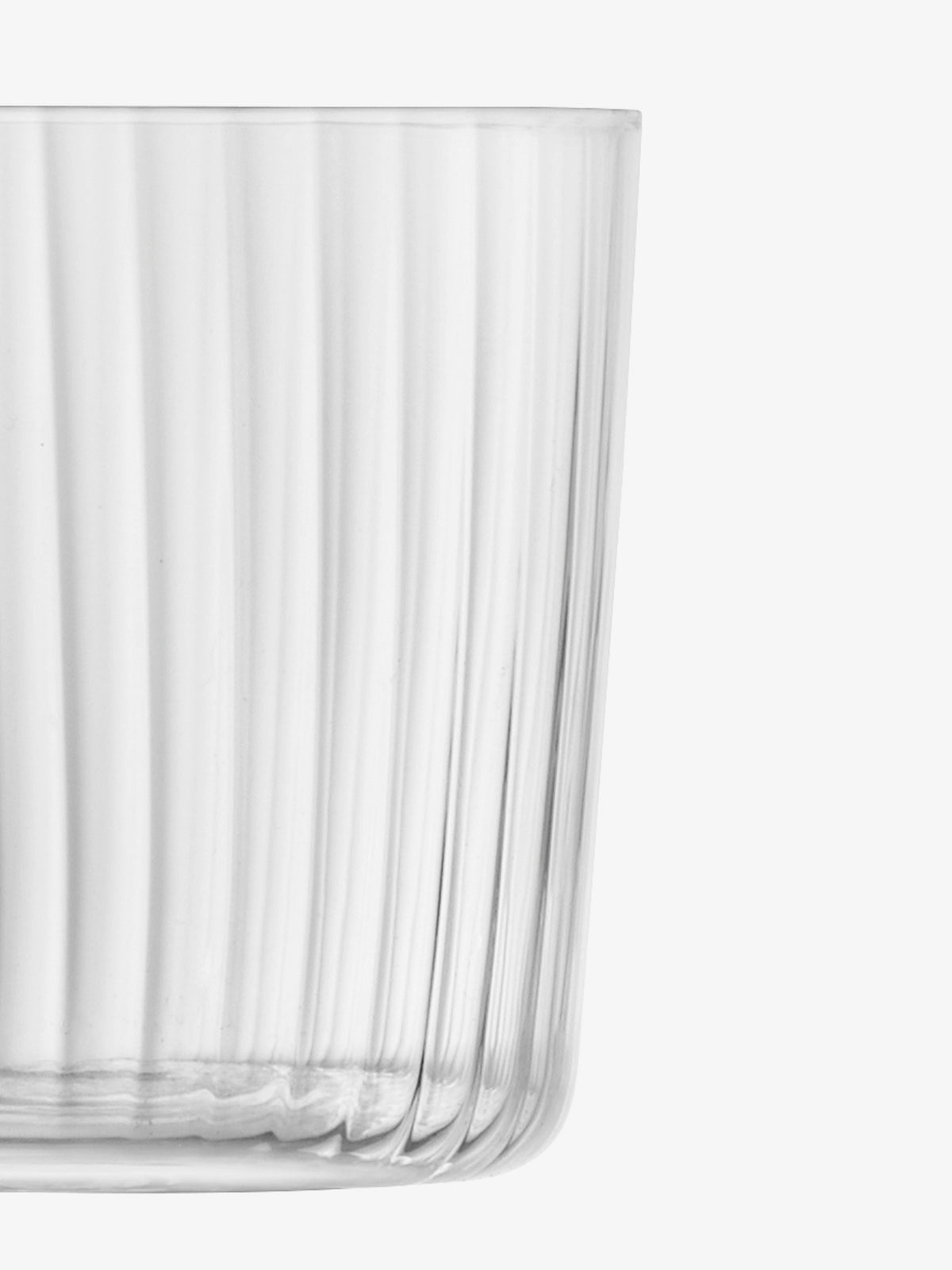 A close-up of the lsa-international Tumbler, featuring clear, fine-walled glass with vertical ribbed lines, is shown on a white background. The image highlights only part of the cup, focusing on the textured and transparent qualities of the glass.