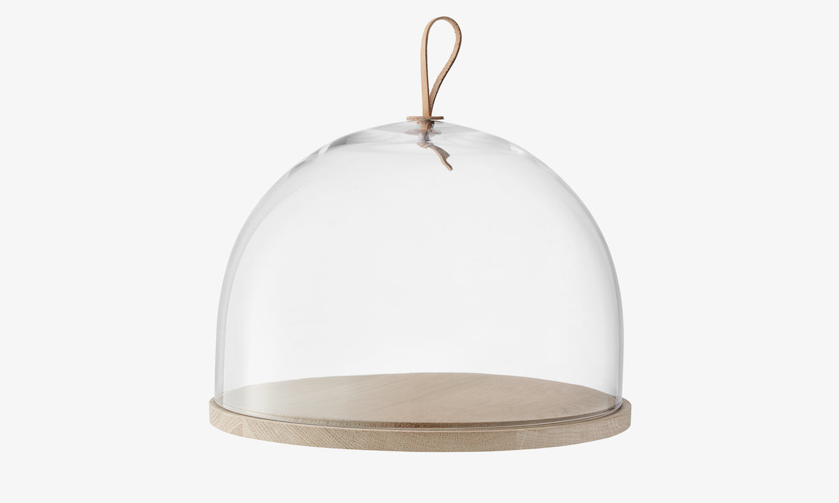 LSA International Dome & Ash Base featuring a glass dome cover with a leather loop handle on a round wooden base.