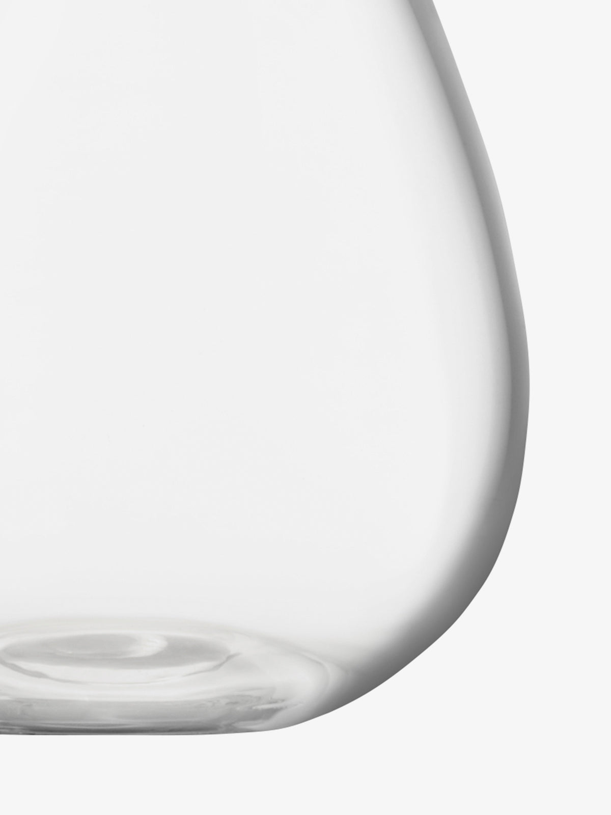 A close-up of the lower part of an empty, clear Mini Table Vase by lsa-international, featuring a curved silhouette against a white background—ideal for showcasing petite floral arrangements as an elegant bud vase.
