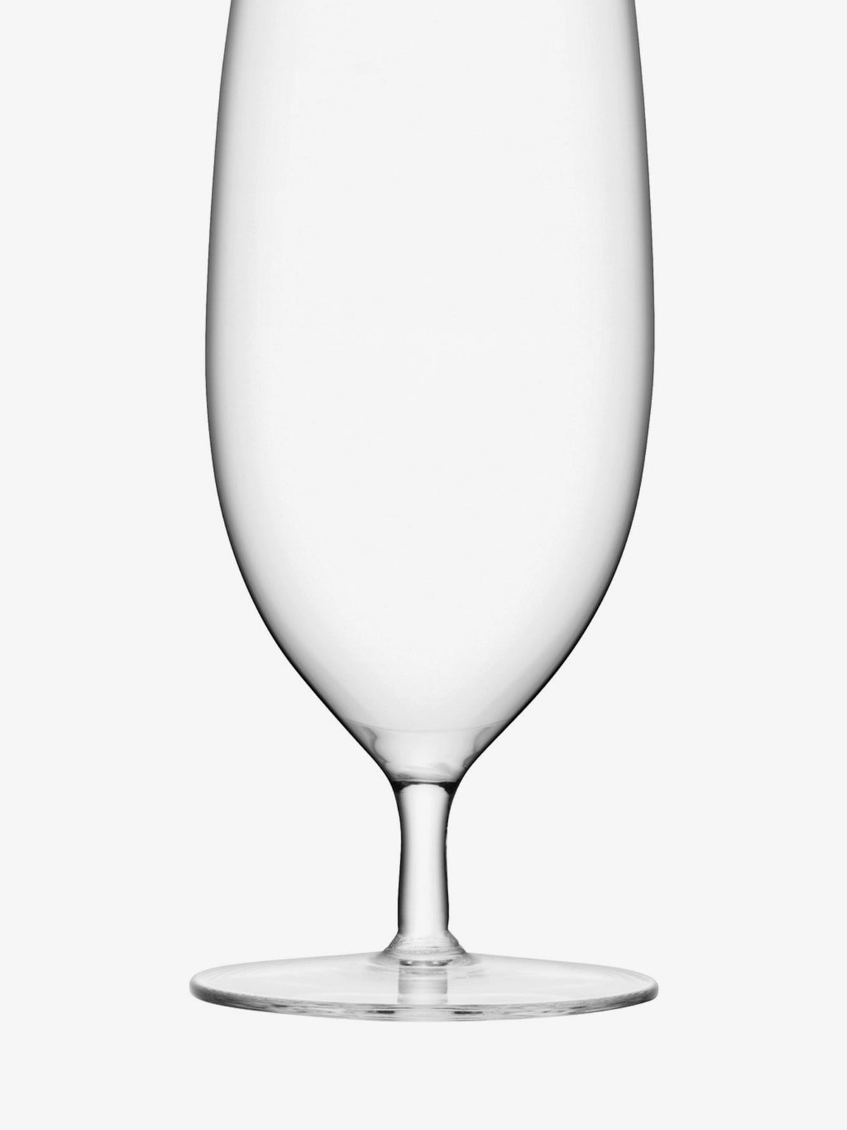 A clear, empty stemmed glass with a wide bowl and a flat base is shown against a white background.