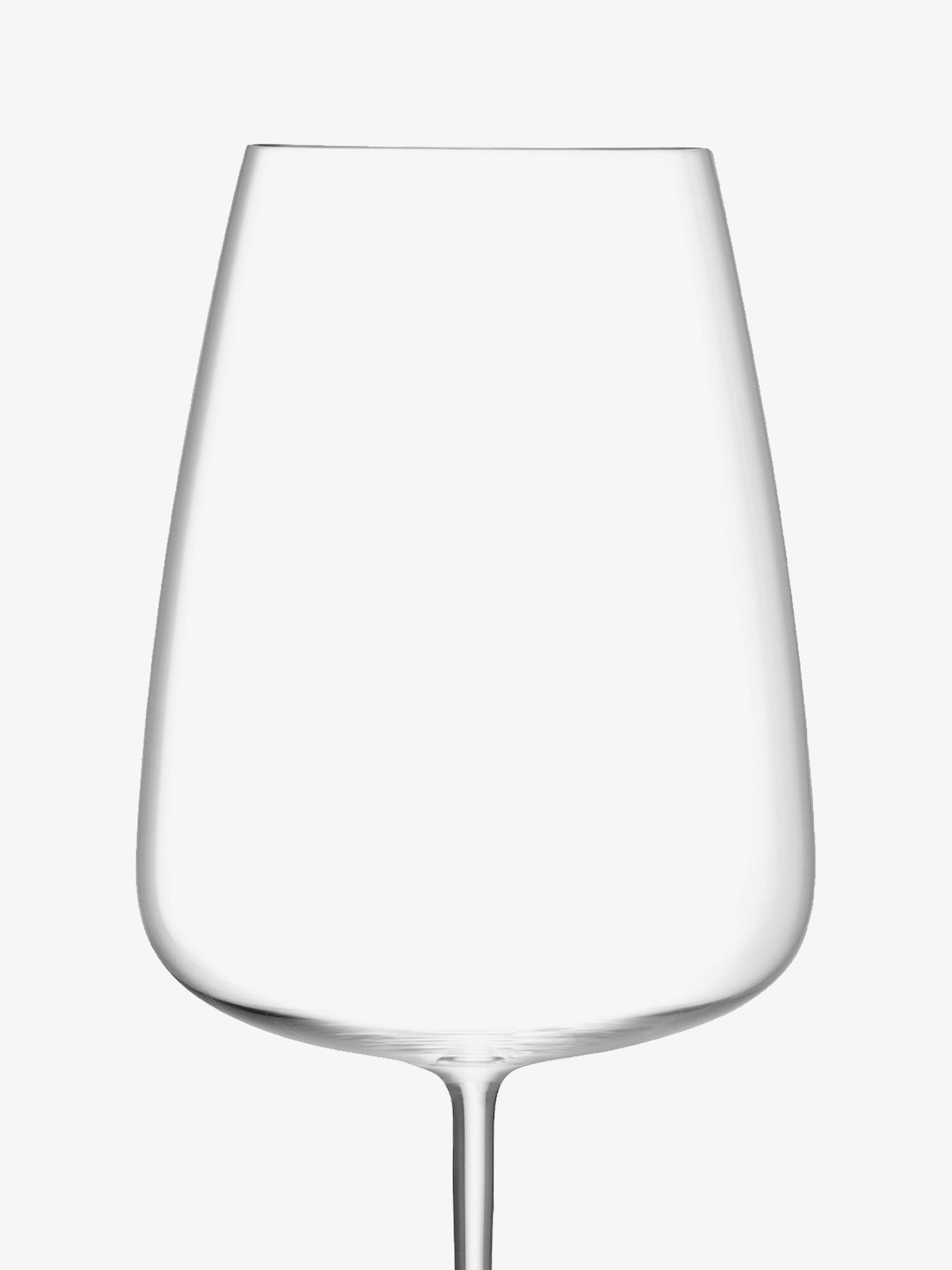 The lsa-international Red Wine Grand Glass, with its thin stem and clear, modern design, is mouth blown and hand crafted. Set against a plain white background, this exquisite glass showcases elegant craftsmanship and sophistication.