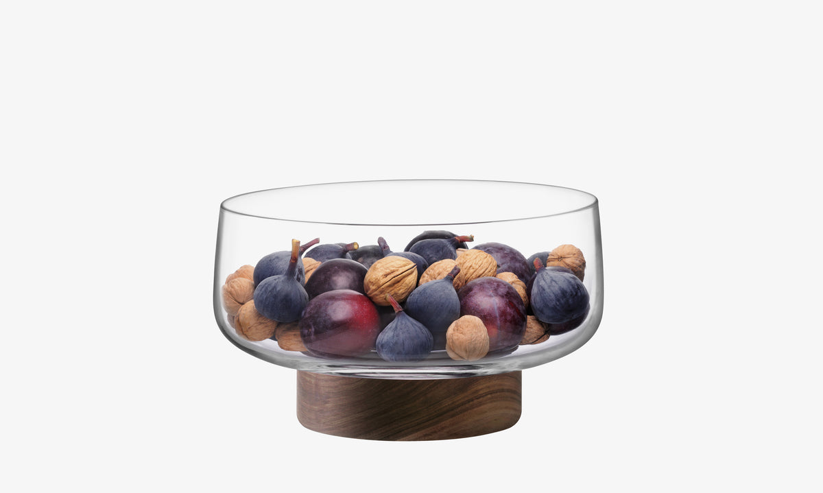 The Bowl & Walnut Base by lsa-international, filled with plums, figs, and walnuts, creates an elegant display that stands out against a plain white background.