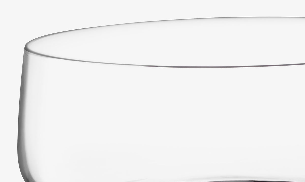 Close-up of the upper part of a clear, empty lsa-international Bowl & Walnut Base with a smooth rim, set against a plain white background.