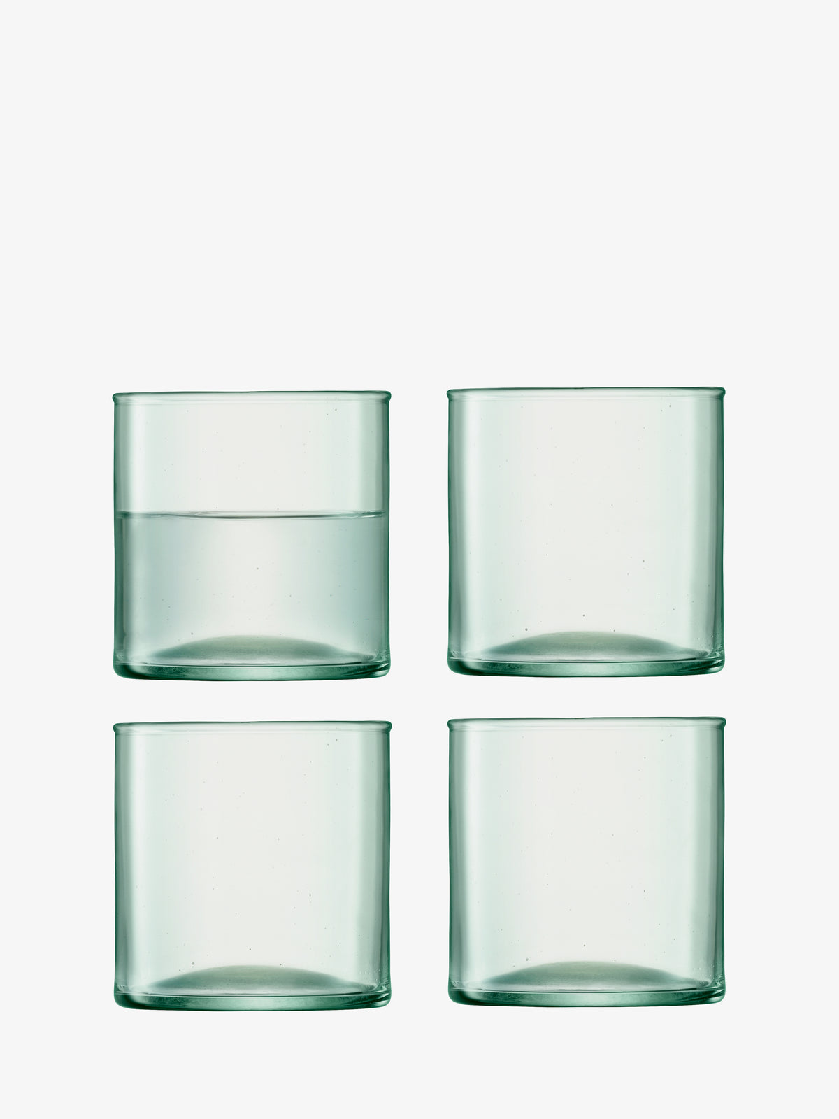 Four clear, cylindrical Tumbler glasses by lsa-international—crafted from sustainable, recycled glass—are arranged in a 2x2 grid. Only the top left Tumbler contains water, while the other three are empty. The background is plain white.