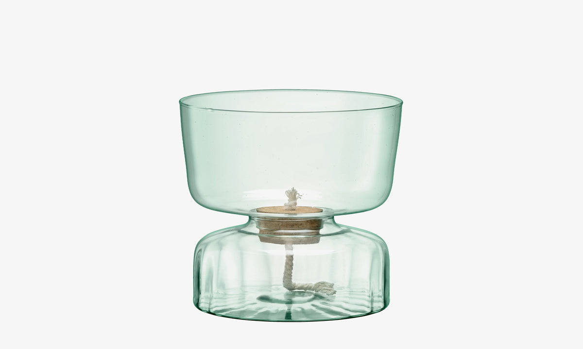 The Self Watering Planter Clear/Part Optic by lsa-international is a clear, light green glass piece with a wide, rounded top and a narrower, rounded base—crafted from recycled glass. Set against a plain white background, this unique design can also be repurposed as an eco-friendly planter for your favorite small plants.