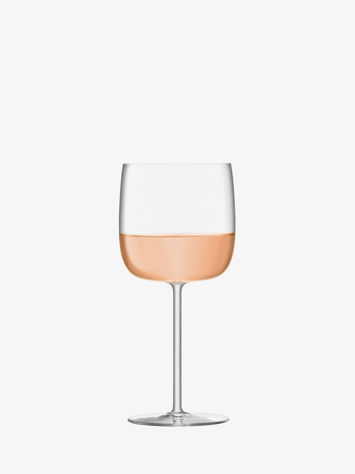 A clear lsa-international Wine Glass with a tall stem, half-filled with light pink rosé, stands centered against a plain white background.