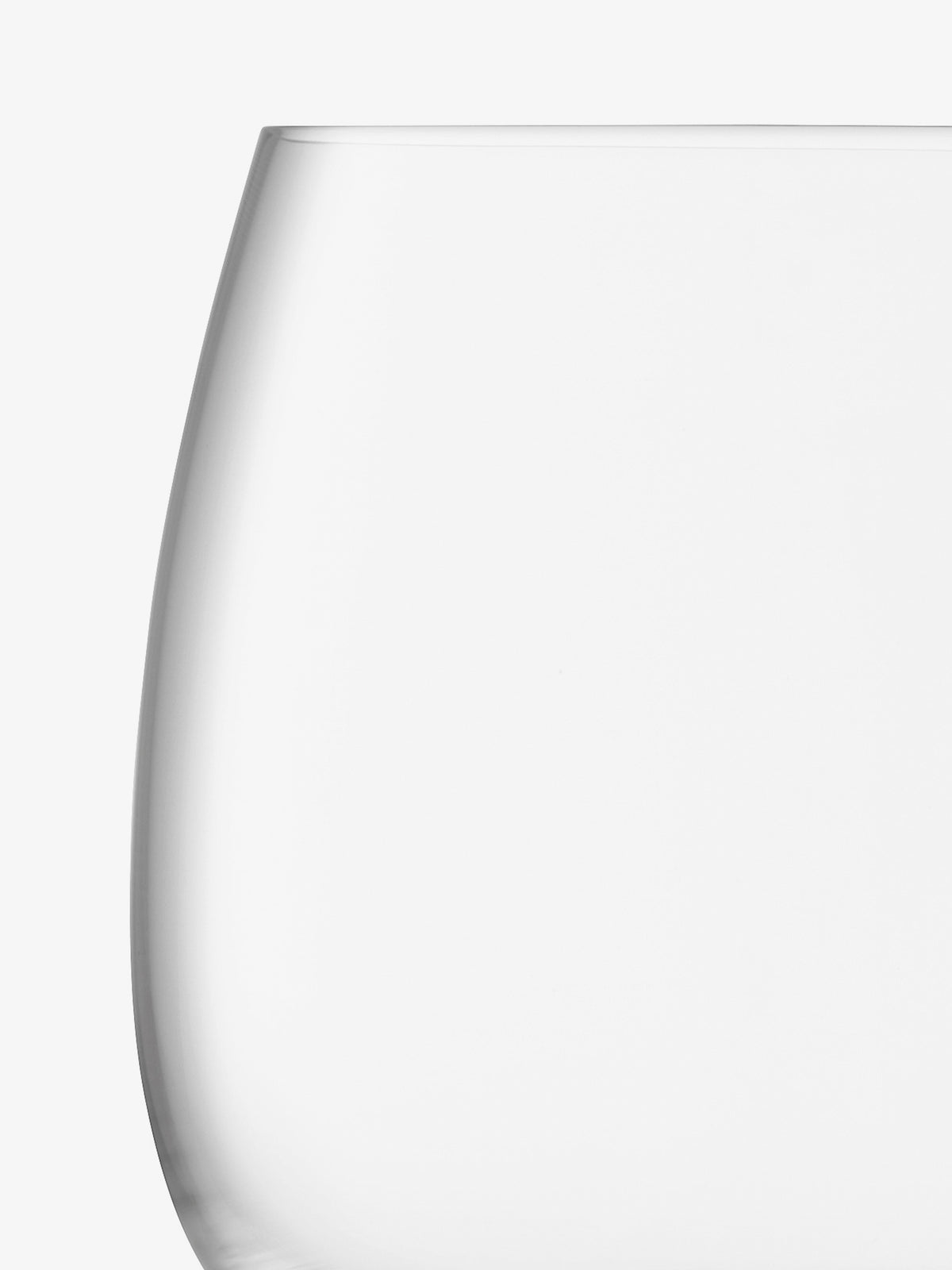 Here’s the revised sentence using your product data: A close-up of an empty, clear lsa-international Stemless Glass, crafted from crystalline glass, is set against a white background, showing only the top part and one curved side of the glass.