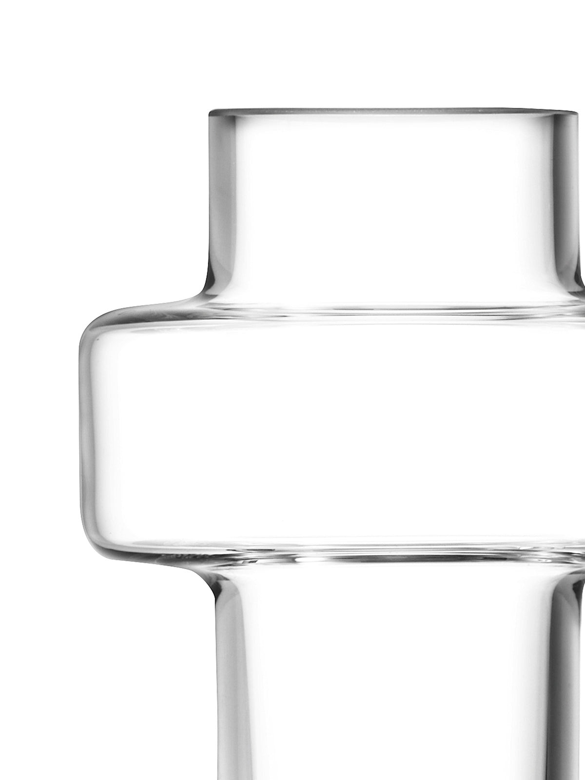 A close-up of a Five Mini Vase Set mouth-blown glass vase featuring a geometric, stepped silhouette reminiscent of Brutalist architecture.