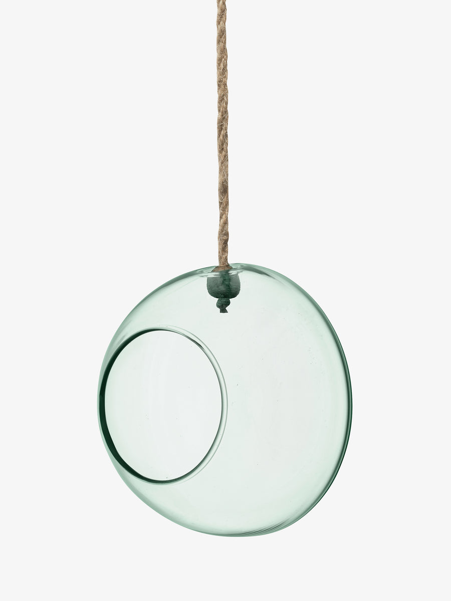 A round, transparent recycled glass Hanging Planter by lsa-international, featuring a large circular opening, hangs by a thick brown rope against a plain white background.