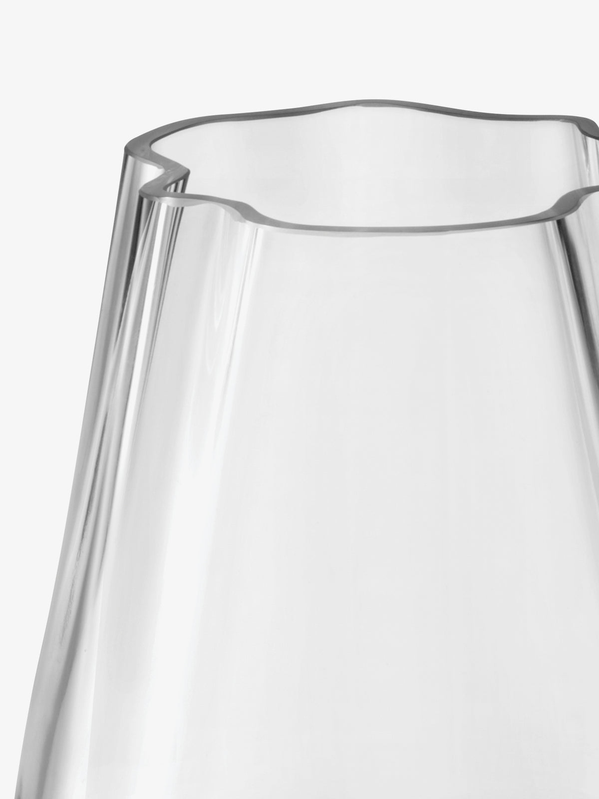 A clear, mouth-blown LSA-International Vase/Lantern with an organic form and a scalloped, flower-shaped rim.