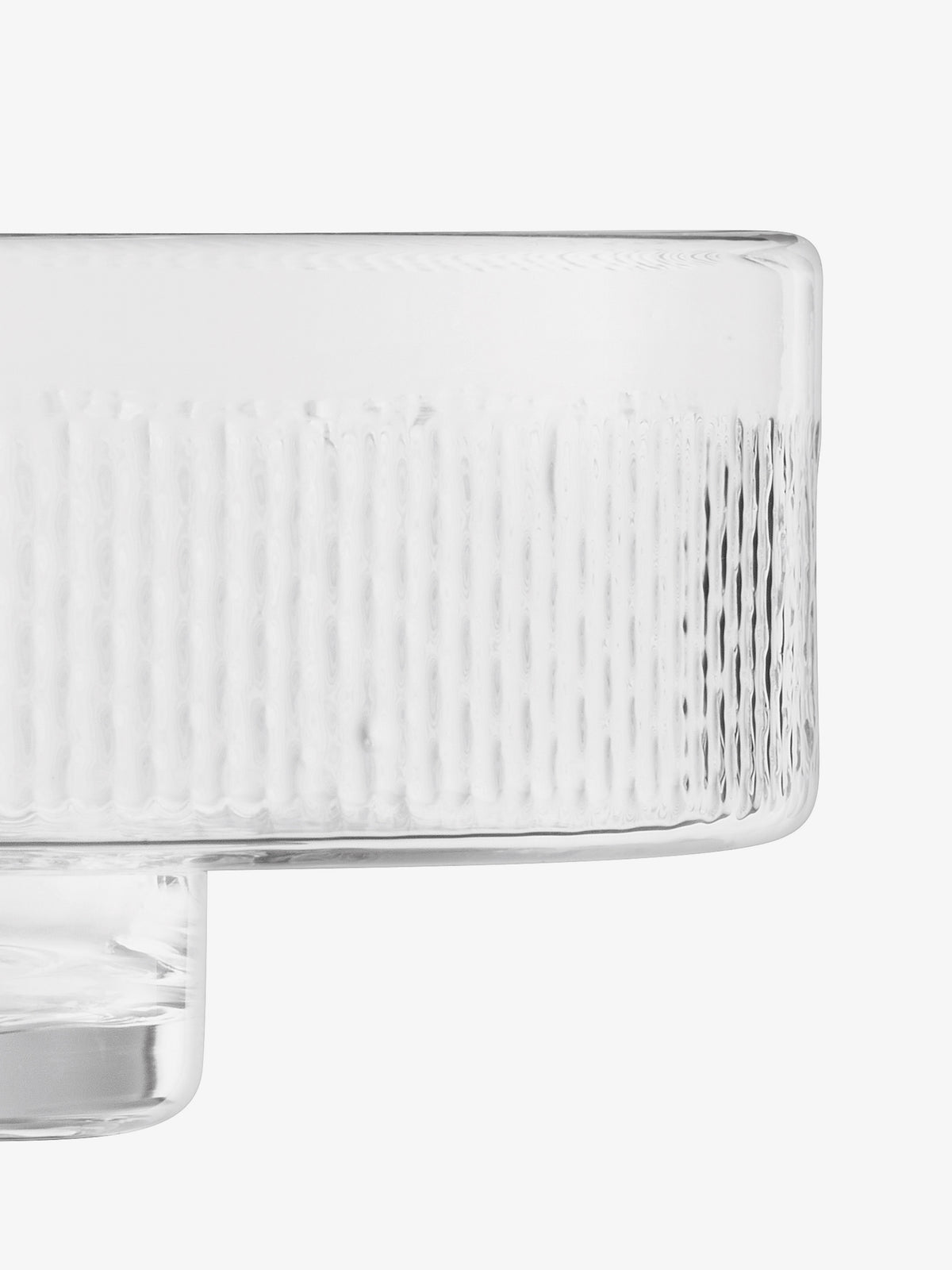 A close-up of the lsa-international Comport, a clear glass bowl with vertical textured lines along the sides, set against a white background. Only the upper half and part of the pillar stem are visible, emphasizing the elegant form of this decorative piece.