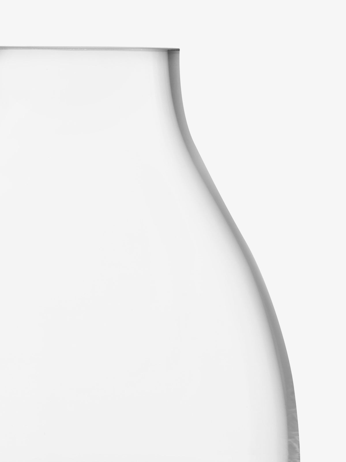 A close-up of the upper portion of the transparent, curved Kiln Vase by lsa-international, set against a plain white background.