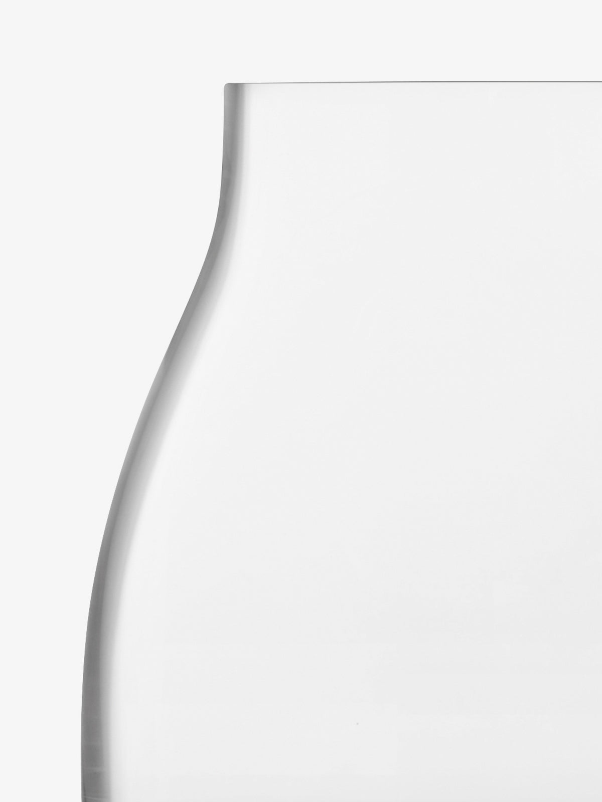 A close-up of the Kiln Vase by lsa-international, a clear, empty mouth-blown glass piece displayed against a plain white background, highlighting the smooth and simple curves of its body and neck.