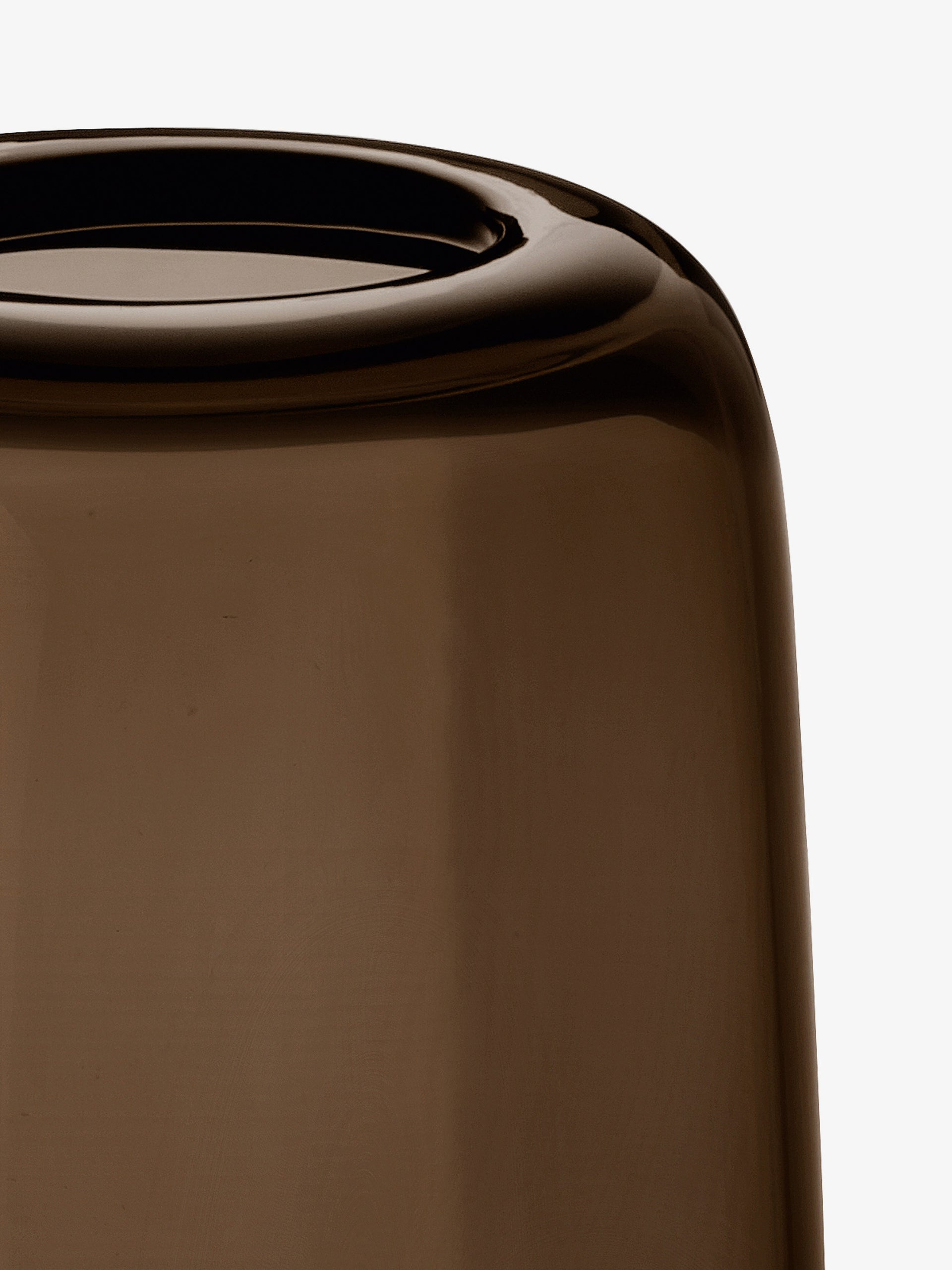 A close-up of an inverted, translucent brown lsa-international Vase made from mouth blown glass on a white background, highlighting its smooth, glossy surface and curved edges.