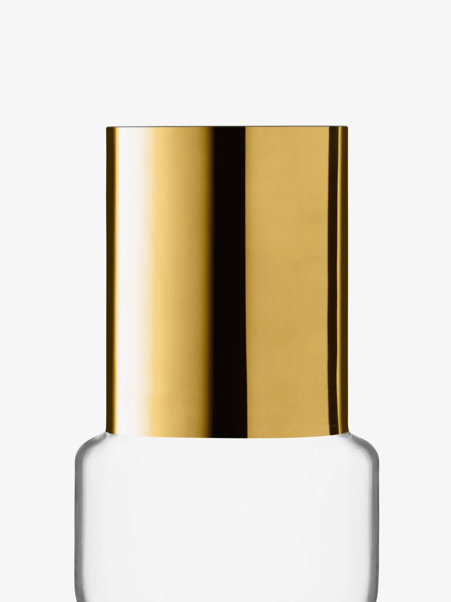 A close-up of a clear bottle with a shiny gold cylindrical cap against a plain white background.