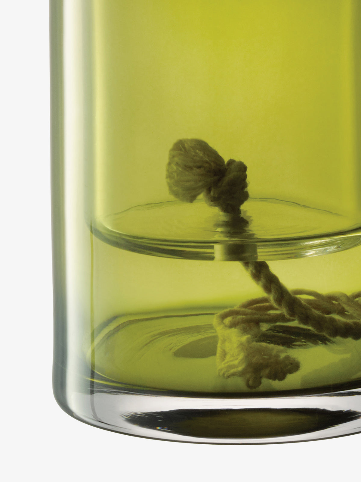 LSA International Self Watering Planter made of clear glass with a thick, knotted cotton wick submerged in a light green liquid.