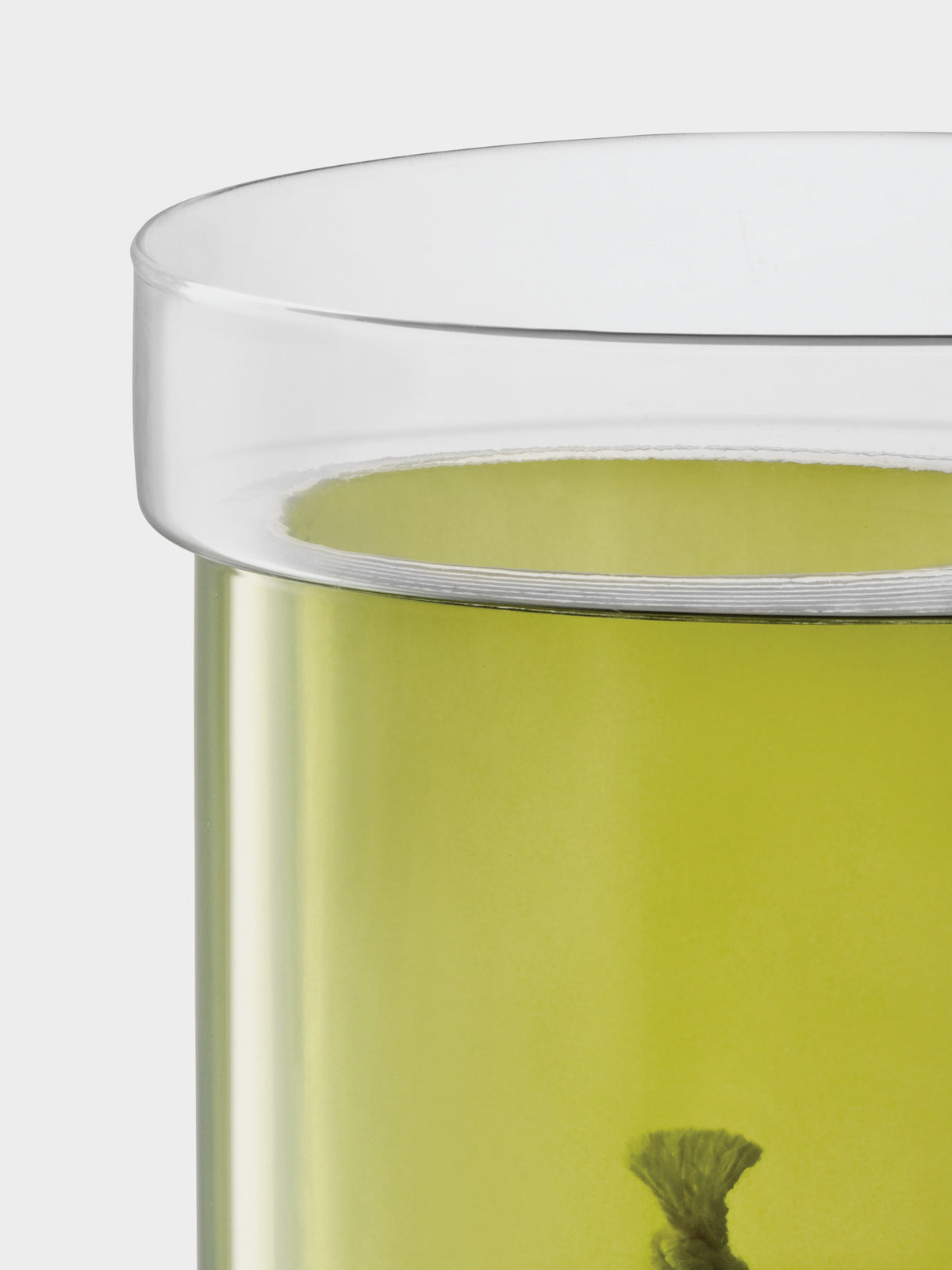 An lsa-international Self Watering Planter featuring a clear glass base and a lime-green inner vessel with a wick at the bottom.