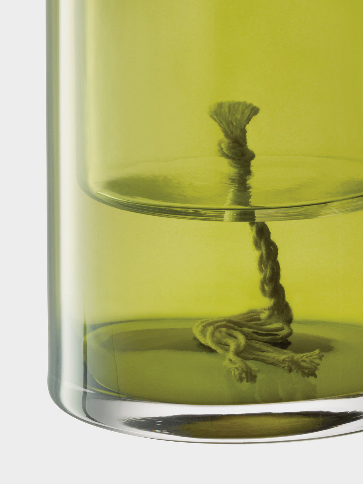 A close-up of an LSA-International Self Watering Planter containing lime green liquid and a cotton wick.