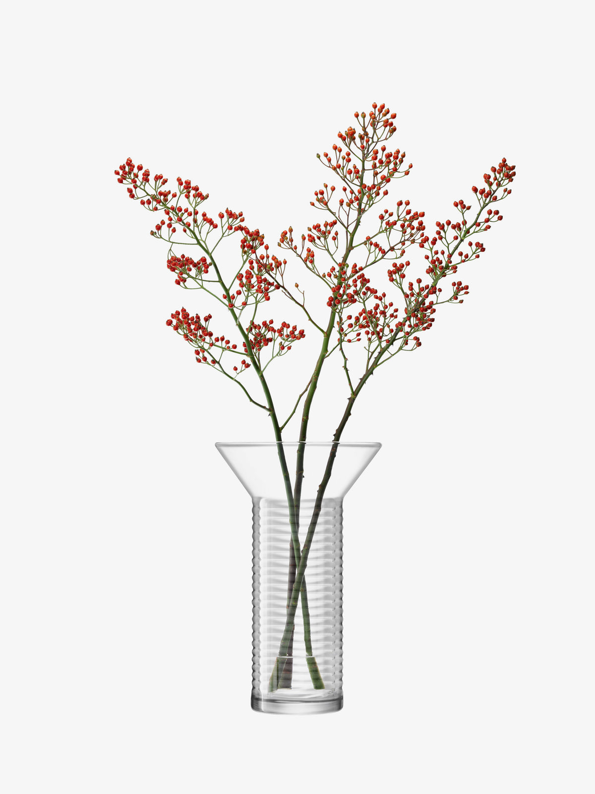 Contemporary lsa-international mouth-blown glass vase with a flared top and ribbed cylindrical base, containing three branches with small red berries.