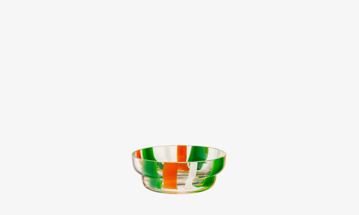 The lsa-international Bowl is a small mouth-blown piece with vertical orange, green, and white folk-inspired stripes, shown centered on a plain white background.