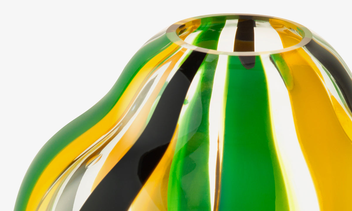 Close-up of lsa-international Vase with vibrant yellow, green, black, and clear wavy stripes and a small rounded opening—an eye-catching table centerpiece.