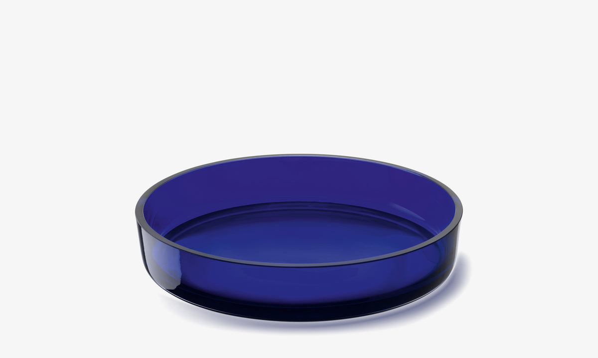 A wide, shallow LSA International Low Glass Bowl made of translucent blue glass.