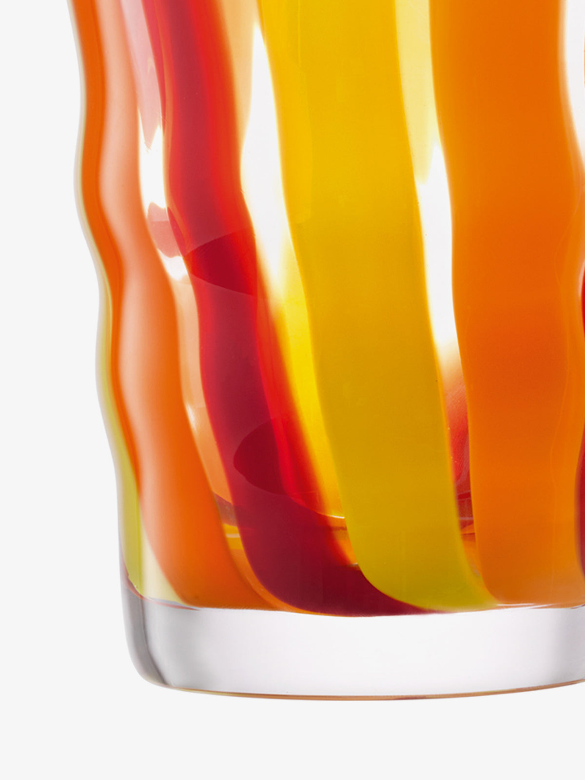 Close-up of lsa-international Container & Ash Lid, a mouth-blown glass with wavy orange, yellow, and red vertical stripes. The transparent base and tapered shape stand out against the white background.