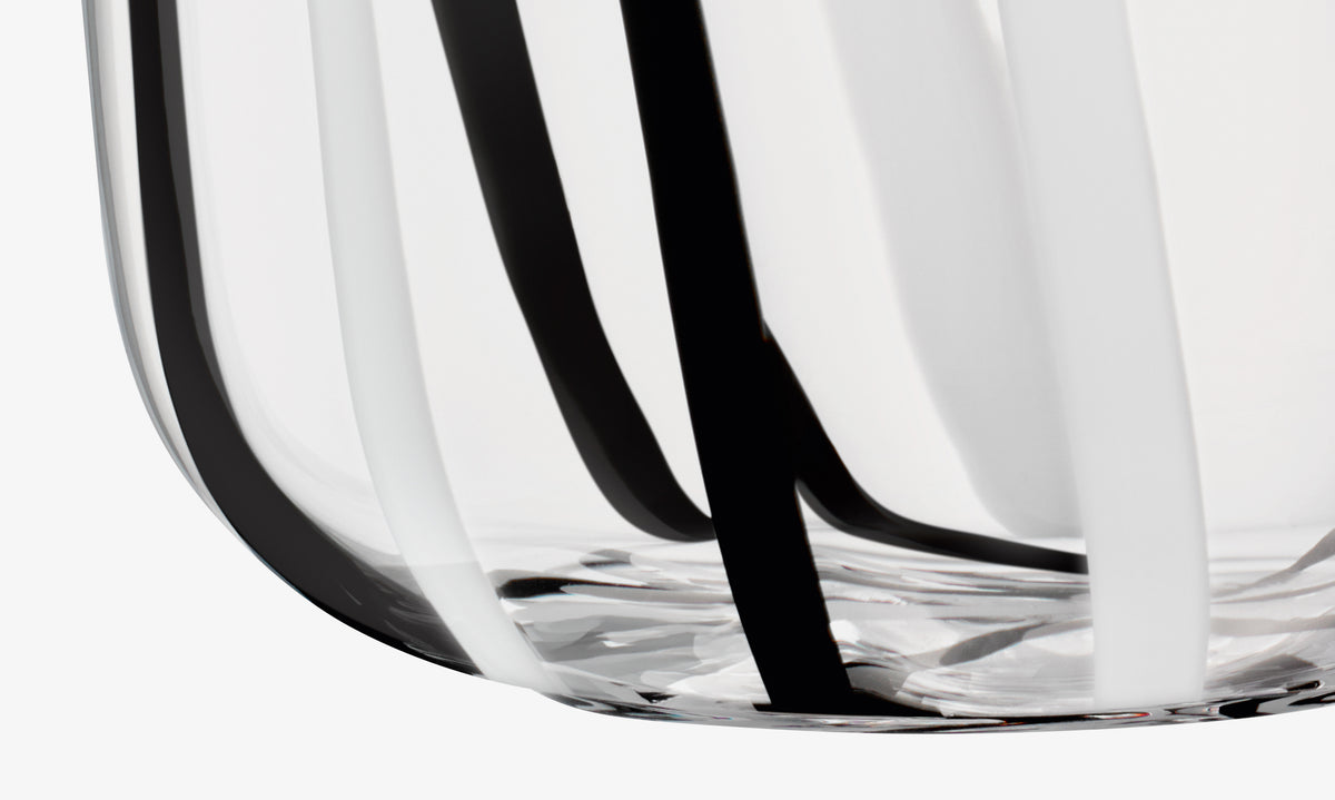 LSA International mouth-blown, bulb-shaped glass vase decorated with vertical black and white stripes.