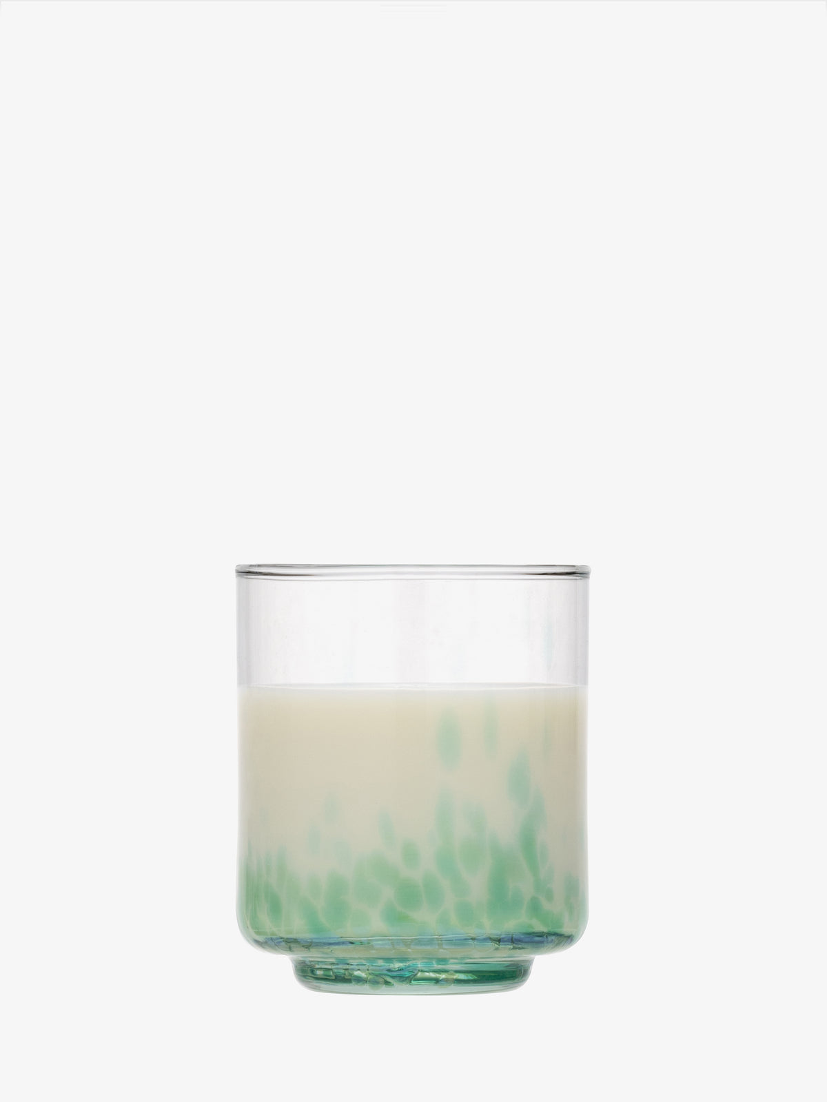 A clear speckled lsa-international Tumbler filled with a milky white liquid, displaying green spots settled at the bottom, set against a plain white background.