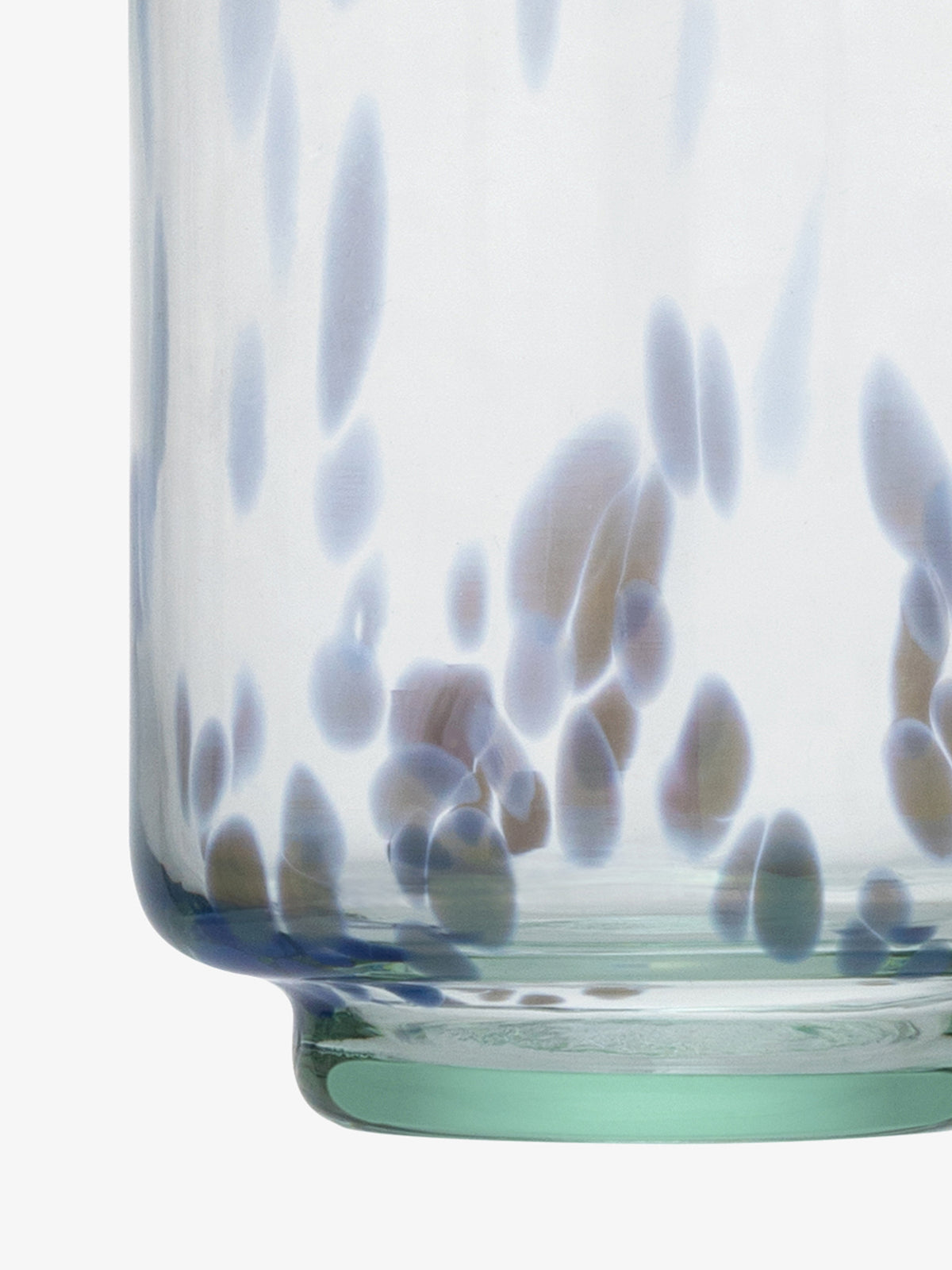 Close-up of the base of an lsa-international Tumbler made from transparent recycled glass, featuring blue and brown speckled patterns on its surface.