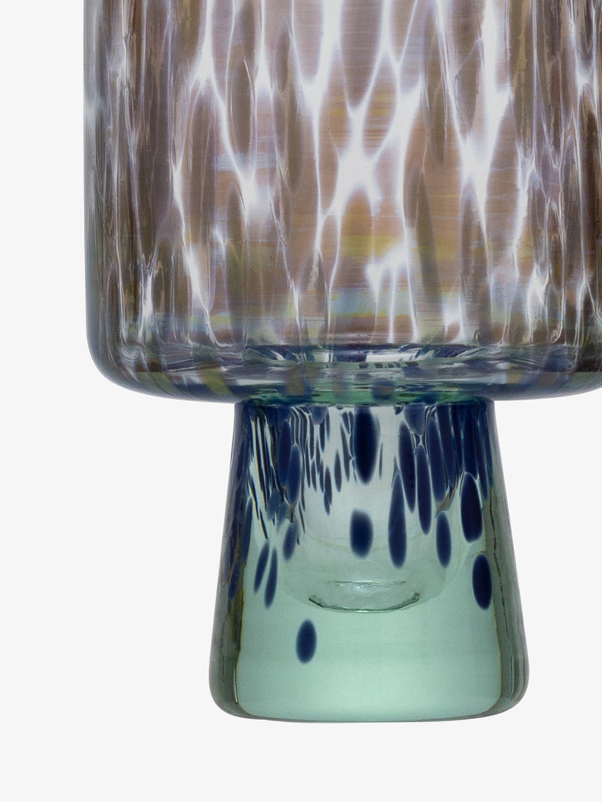 A close-up of the lsa-international Wine Glass, crafted from recycled glass with a patterned surface, featuring wavy white and brownish streaks on the top and blue spots on the light green base.