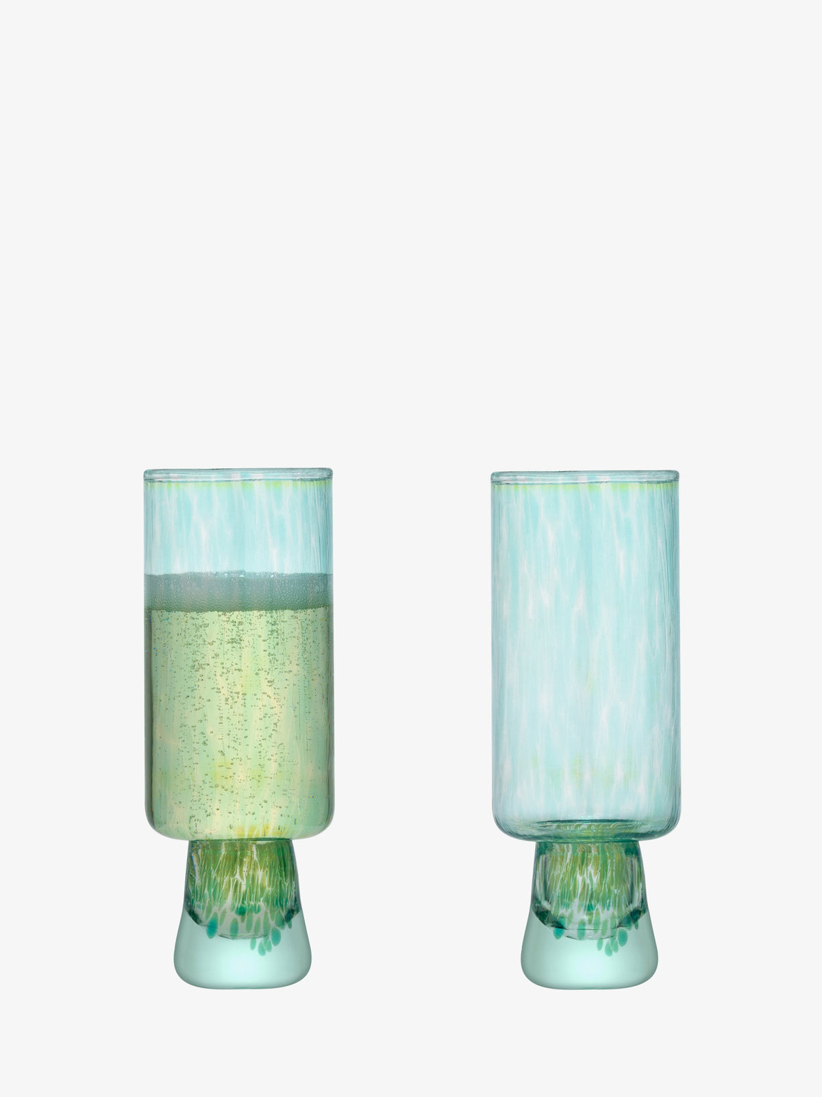 Two contemporary greenish-blue Flute Glasses by lsa-international, crafted from recycled glass with wide bases—one filled with a sparkling light beverage and the other empty—are displayed against a plain white background.