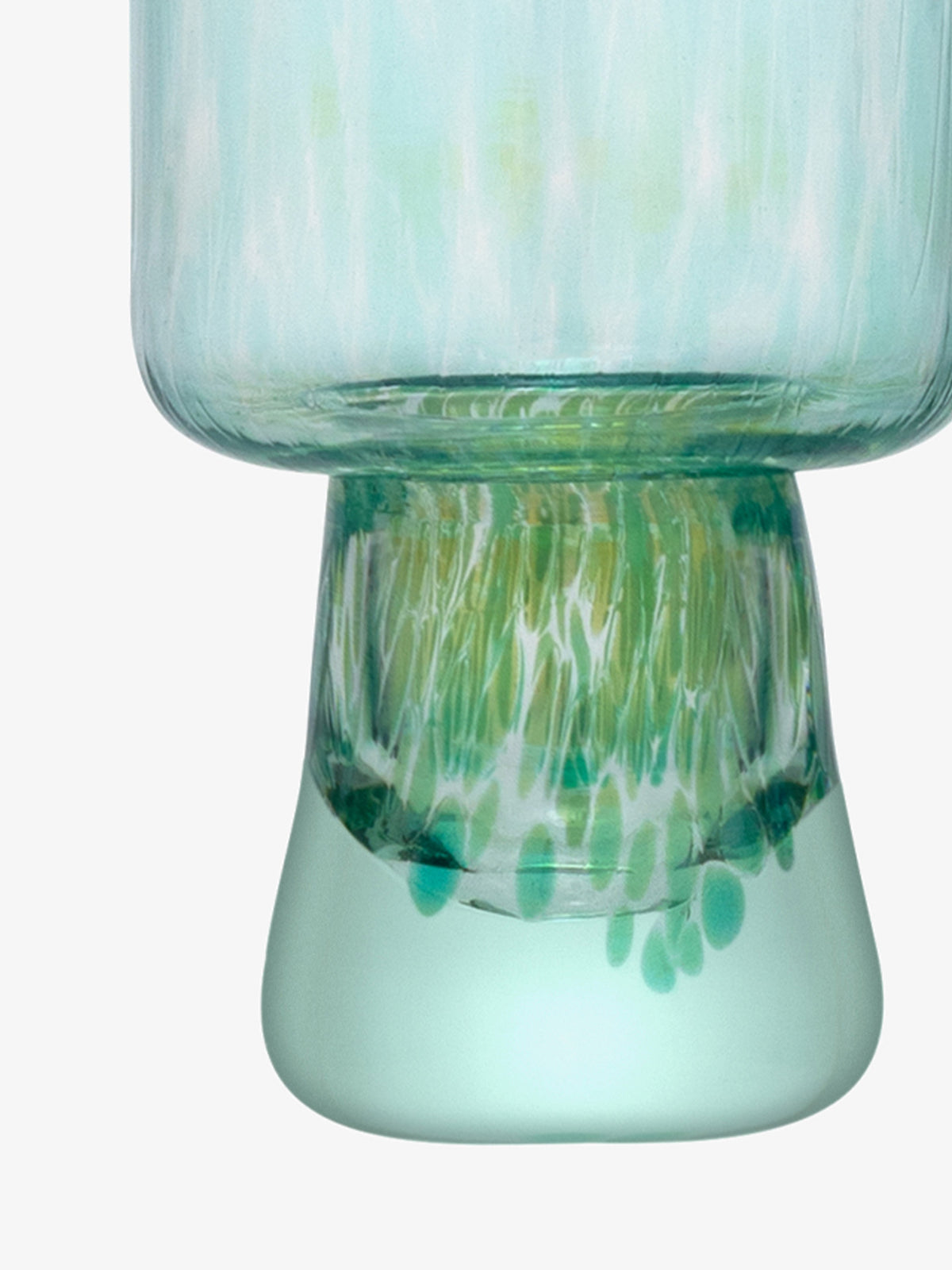 A close-up of the base of the lsa-international Flute Glass, crafted from translucent recycled glass and showcasing blue, green, and white streaks and dots, with a unique rounded shape and textured pattern.