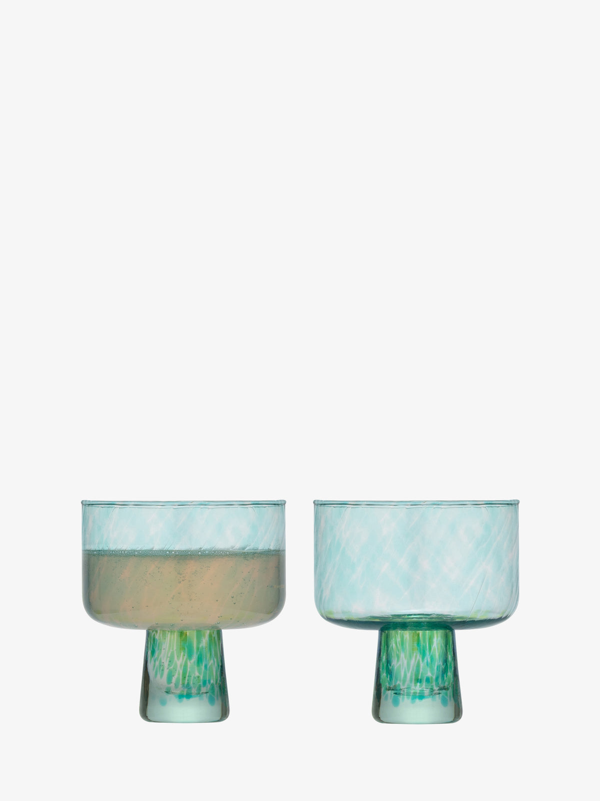 Two lsa-international Cocktail Saucers in light blue glass with green bases—evoking sea glass decor—are displayed against a plain white background, one filled with a pale liquid and the other empty.