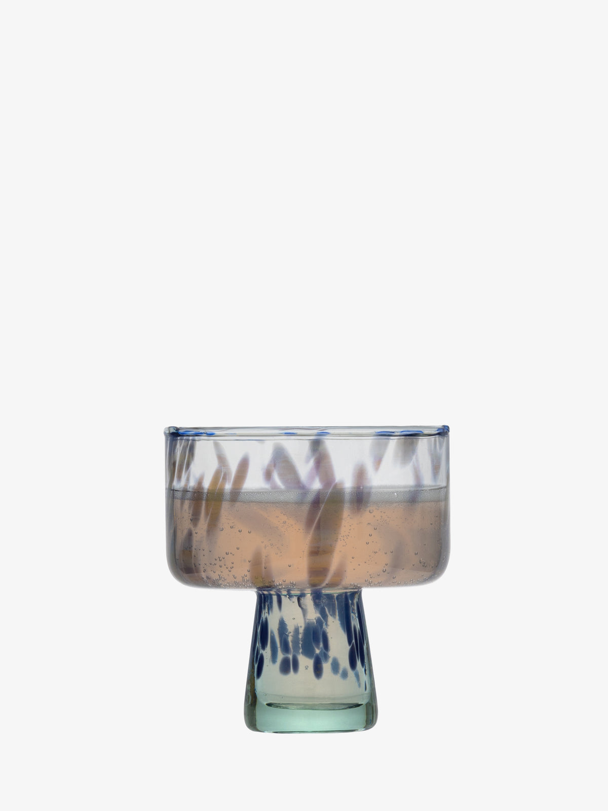 The lsa-international Cocktail Saucer, crafted from recycled clear glass with a rounded bowl and short stem, is decorated with blue speckles and shown holding a light pink fizzy drink against a plain white background.