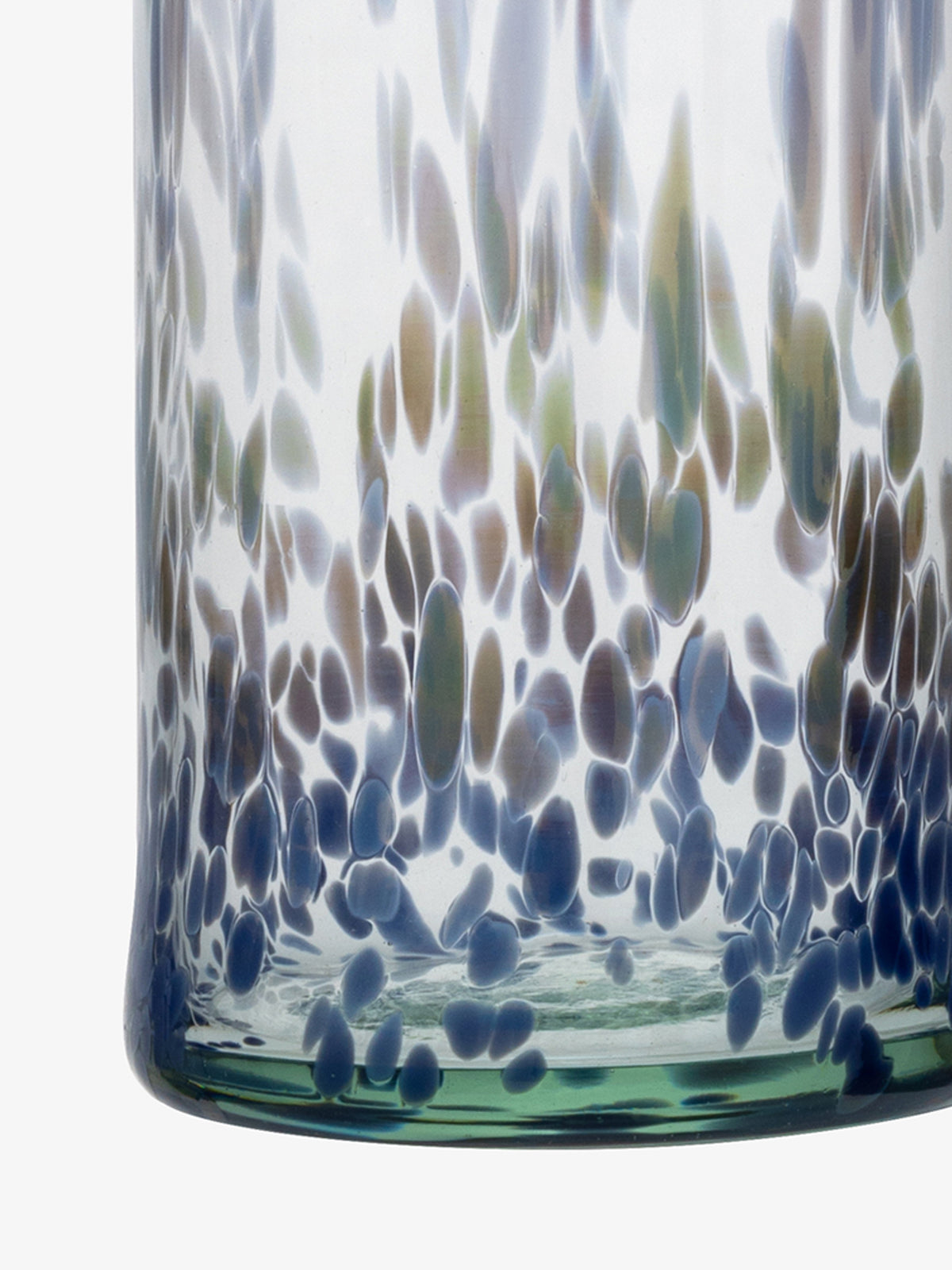 A close-up of the lsa-international Carafe, crafted from recycled glass, featuring blue, green, and brown speckled patterns on a clear background with textured, oval-shaped spots clustered near the base.