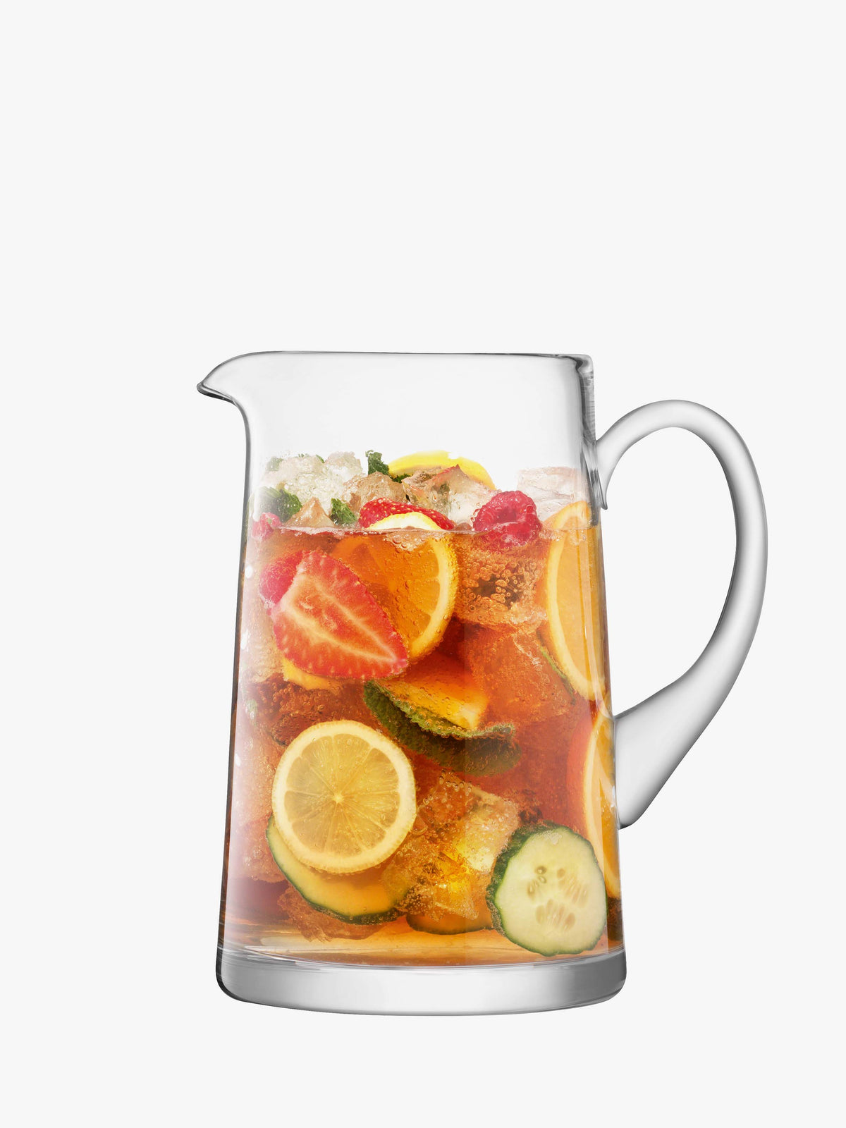 A clear, mouth-blown Tapered Jug by lsa-international filled with iced tea, slices of lemon, lime, cucumber, strawberries, fresh mint leaves, and ice cubes.