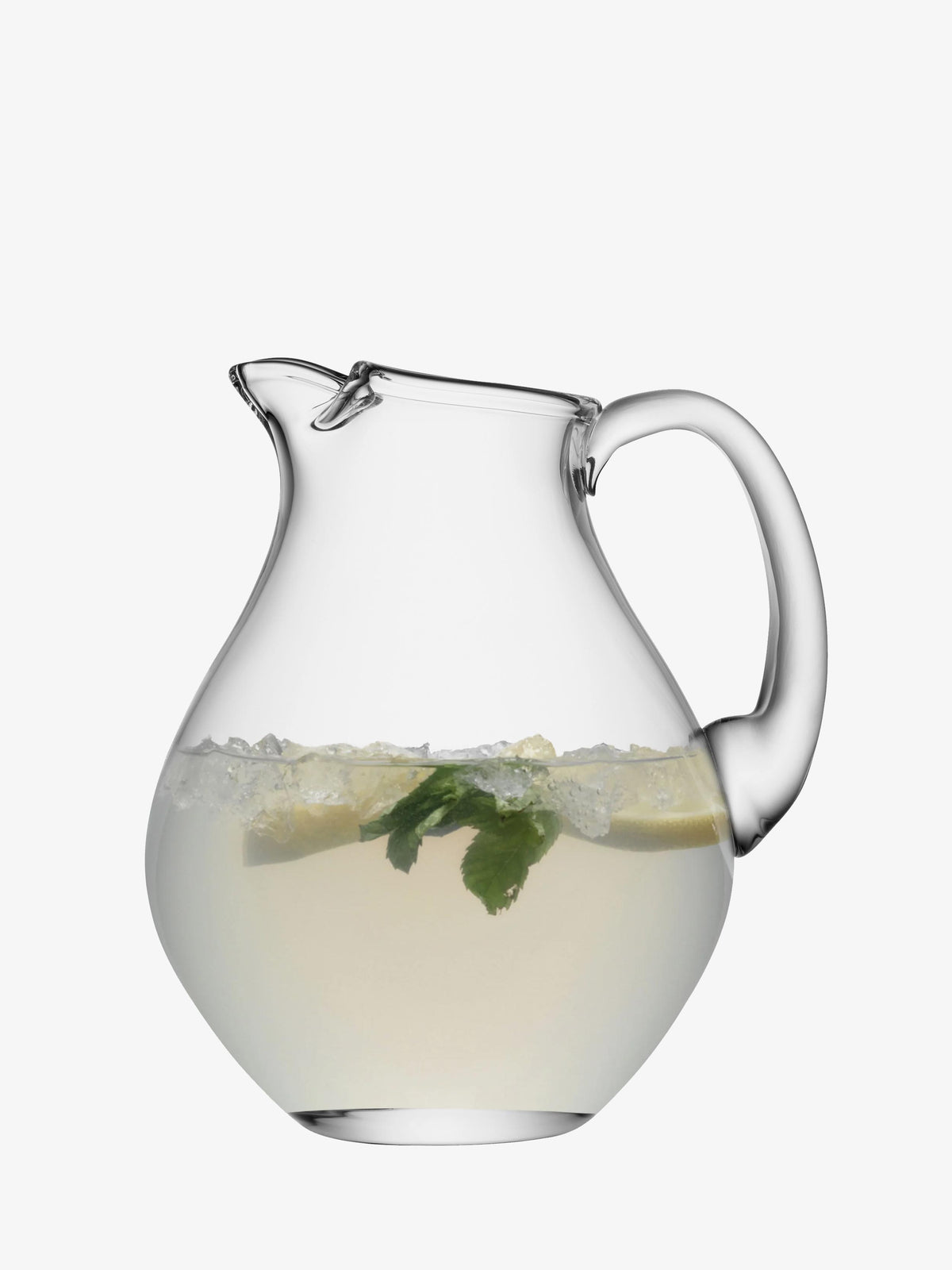 An Icelip Jug by lsa-international, made from clear mouth-blown glass, is filled halfway with a light-colored drink, ice, lemon slices, and mint leaves, and is set against a plain white background.