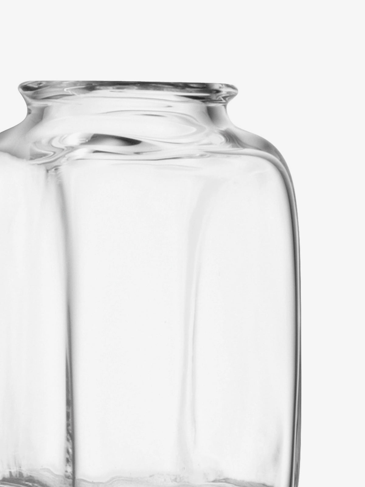 A close-up of a clear, empty glass jar with a wide mouth against a white background.